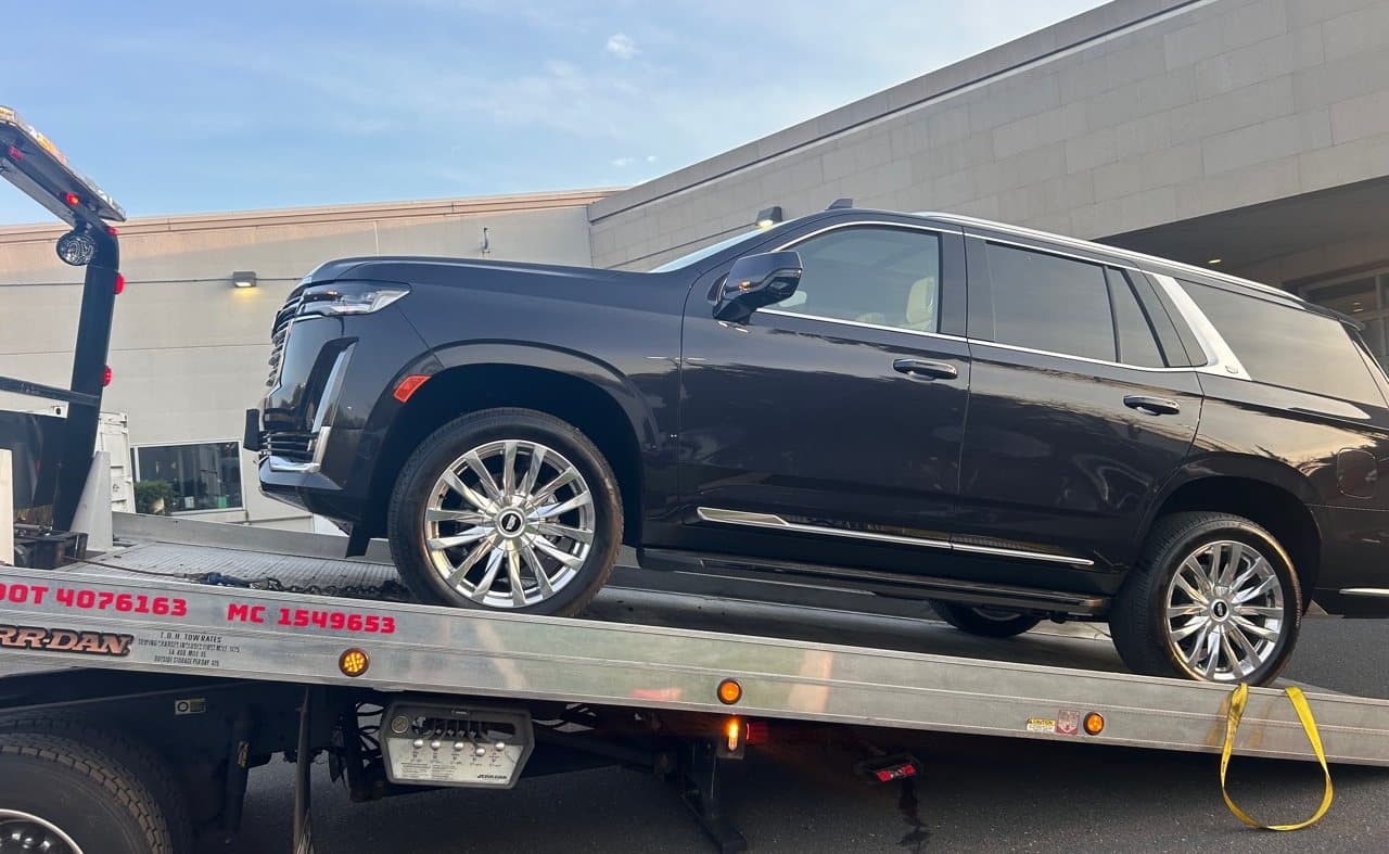 Luxury SUV towing in Holmdel NJ on a Road Heroes flatbed