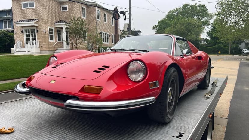 Classic Ferrari Dino being transported on flatbed tow truck